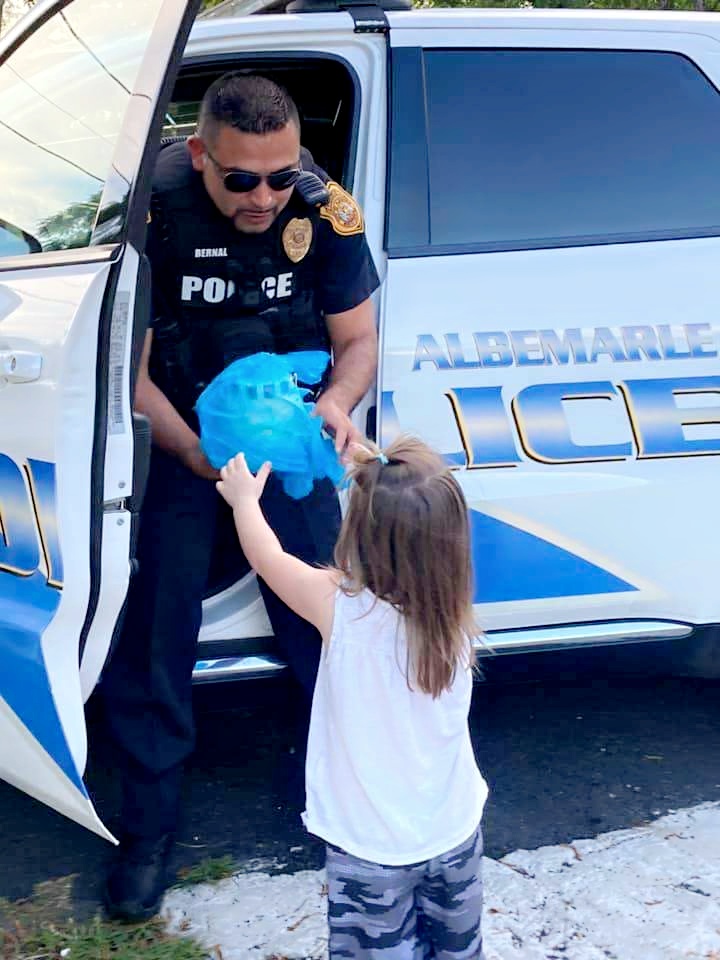 Officer Bernal hands girl ice cream